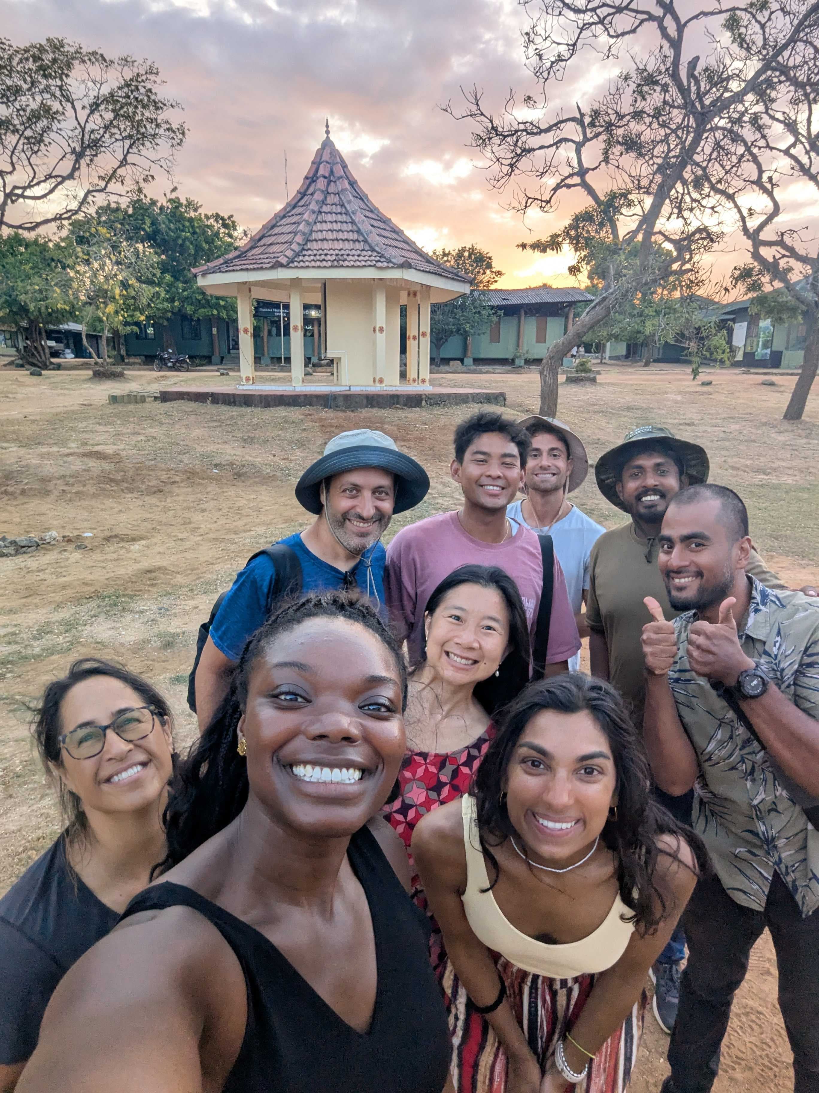 Large diverse group selfie at golden hour
