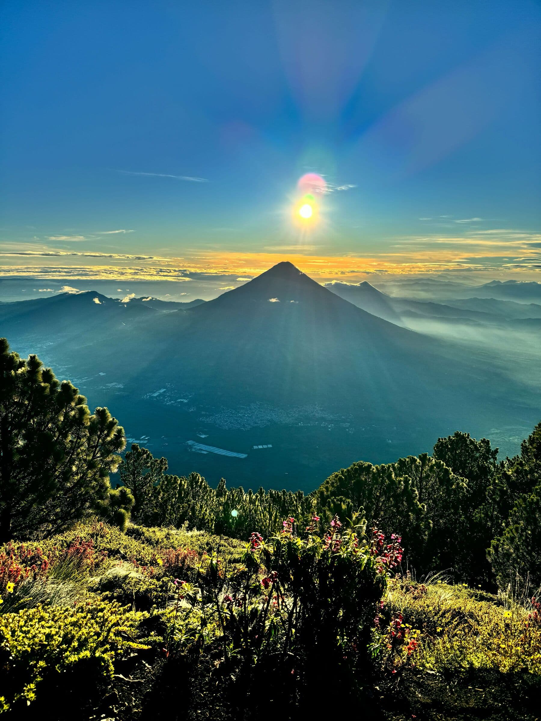 Community members watching the sunrise from a volcano
