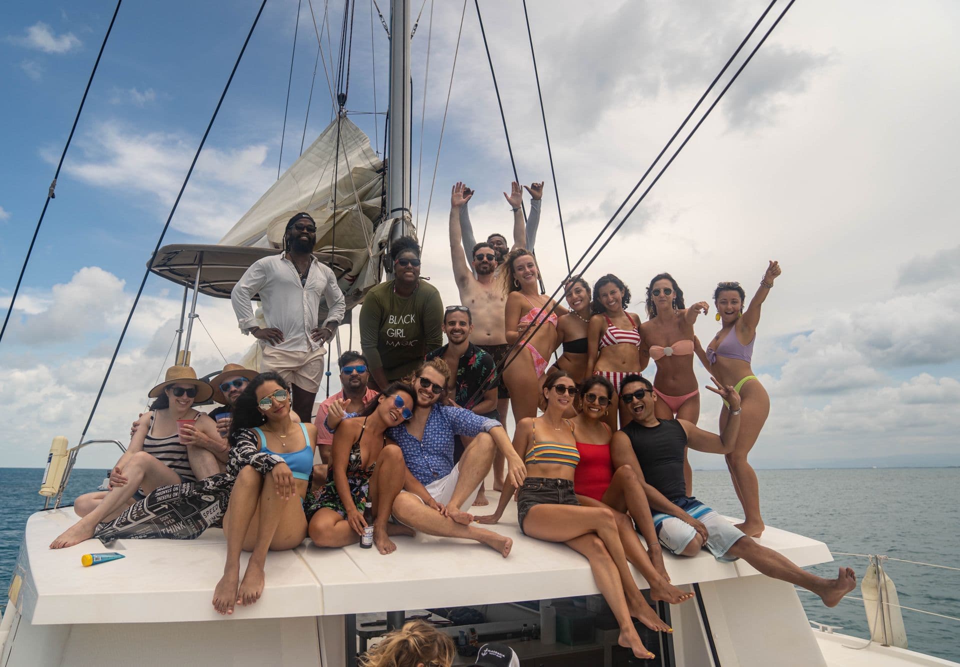 A group of friends gathered on the deck of a sailboat